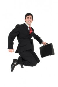Young businessman jumping in the air